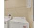 A laundry room with a side-by-side washer and dryer and a wire rack shelf at 540 Monroe Cir, Davenport, FL 33896