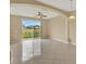 Bright living room with tile floors, ceiling fan, and sliding glass doors to the backyard at 540 Monroe Cir, Davenport, FL 33896