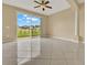 Open living room with tile floors, ceiling fan, and a sliding door with backyard views at 540 Monroe Cir, Davenport, FL 33896