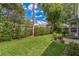 Well-maintained backyard featuring lush green grass, a stone patio, and a barbecue grill at 544 Remington Oak Dr, Lake Mary, FL 32746