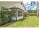 Backyard with a grilling area, lush green lawn and an adjacent screened-in porch at 544 Remington Oak Dr, Lake Mary, FL 32746