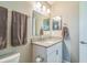 Bright bathroom featuring granite countertop, white vanity, and a well-lit mirror for a clean and modern look at 544 Remington Oak Dr, Lake Mary, FL 32746