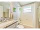 Bright bathroom with granite countertop, white vanity, and combination tub/shower, offering a functional and stylish space at 544 Remington Oak Dr, Lake Mary, FL 32746