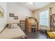 Comfortable bedroom with hardwood floors, single bed, wooden desk, and bright window, creating an efficient and inviting space at 544 Remington Oak Dr, Lake Mary, FL 32746