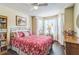 Cozy bedroom with hardwood floors, bay window, and a comfortable bed, creating a relaxing and inviting atmosphere at 544 Remington Oak Dr, Lake Mary, FL 32746