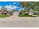 Charming single-Gathering home with a well-maintained lawn, mature trees, and a welcoming facade, showcasing curb appeal at 544 Remington Oak Dr, Lake Mary, FL 32746