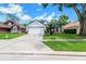 Single story home with a well maintained front yard, driveway and attached garage at 544 Remington Oak Dr, Lake Mary, FL 32746
