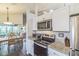 Bright kitchen with stainless steel appliances is next to dining area at 544 Remington Oak Dr, Lake Mary, FL 32746