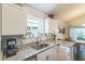 Bright kitchen with granite countertops, stainless steel appliances, and an adjacent dining area at 544 Remington Oak Dr, Lake Mary, FL 32746