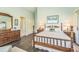 Well-lit main bedroom featuring hardwood floors, wood furniture, and a sliding door to the backyard at 544 Remington Oak Dr, Lake Mary, FL 32746