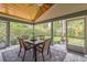 Outdoor screened porch with stone floors, ceiling fan, and dining set at 544 Remington Oak Dr, Lake Mary, FL 32746
