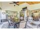 Covered outdoor patio with dining set, stone floors, and backyard view at 544 Remington Oak Dr, Lake Mary, FL 32746