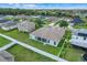 An aerial view shows a house with a fenced backyard surrounded by a green landscape at 560 Viceroy Ct, Kissimmee, FL 34758