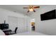 Bright bedroom features a ceiling fan, TV, and closet at 560 Viceroy Ct, Kissimmee, FL 34758
