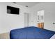 Bright bedroom with a blue comforter, TV, and an ensuite bathroom at 560 Viceroy Ct, Kissimmee, FL 34758