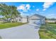 Well-maintained home with a two-car garage, long driveway, and mature landscaping at 560 Viceroy Ct, Kissimmee, FL 34758