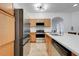 Bright kitchen with stainless appliances, breakfast bar, tile floors and modern lighting at 560 Viceroy Ct, Kissimmee, FL 34758