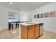 Kitchen island with seating, dishwasher, and sink at 560 Viceroy Ct, Kissimmee, FL 34758