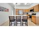 Kitchen with stainless appliances, breakfast bar seating and modern fixtures at 560 Viceroy Ct, Kissimmee, FL 34758
