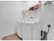 Laundry room with washer, dryer and storage shelf at 560 Viceroy Ct, Kissimmee, FL 34758