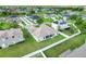 Backyard aerial view featuring a fenced yard, green grass and a screened in lanai at 560 Viceroy Ct, Kissimmee, FL 34758