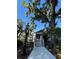 Charming walkway leading to a white house with beautiful landscaping and a vintage lamp post at 629 Helen St, Mount Dora, FL 32757