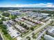Aerial view of apartment buildings with parking and nearby lake at 744 Wyman Ct # 744, Orlando, FL 32809