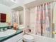 Clean bathroom with a shower-tub combo, white fixtures, and vanity area at 744 Wyman Ct # 744, Orlando, FL 32809