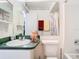 A bathroom featuring a large mirror and vanity with sink and toilet at 744 Wyman Ct # 744, Orlando, FL 32809