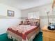 Bedroom featuring a wooden bed frame, matching dresser, and neutral decor at 744 Wyman Ct # 744, Orlando, FL 32809