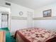 A cozy bedroom with a patchwork quilt and a view to the laundry area at 744 Wyman Ct # 744, Orlando, FL 32809
