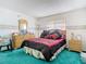 Comfortable bedroom with a patterned bedspread, dresser, and side tables at 744 Wyman Ct # 744, Orlando, FL 32809