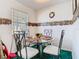 Bright dining room with a glass table, white chairs, and view of the neighborhood at 744 Wyman Ct # 744, Orlando, FL 32809