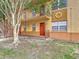 Tan two-story apartment building with a tree and a stairway at 744 Wyman Ct # 744, Orlando, FL 32809