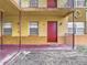Apartment building exterior showing a red door, windows, and covered porch at 744 Wyman Ct # 744, Orlando, FL 32809