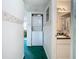 Hallway view of stacked washer/dryer and bathroom with sink and mirror at 744 Wyman Ct # 744, Orlando, FL 32809