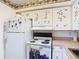 A clean kitchen with white appliances and custom-decorated cabinets at 744 Wyman Ct # 744, Orlando, FL 32809