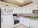 Charming kitchen with white appliances, ample cabinet space, and unique decorative touches at 744 Wyman Ct # 744, Orlando, FL 32809
