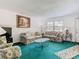 Living room with floral sofas, glass coffee table, and natural light at 744 Wyman Ct # 744, Orlando, FL 32809