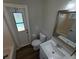 Modern bathroom with white subway tile, updated vanity, and door to the back yard at 7507 Sandstone Dr, Orlando, FL 32836