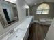 Bathroom with dual sinks, quartz countertops, and a walk-in shower at 7507 Sandstone Dr, Orlando, FL 32836