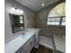 Modern bathroom with a glass shower and an arched window at 7507 Sandstone Dr, Orlando, FL 32836