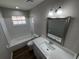 Bright bathroom with white subway tile, updated vanity, and modern fixtures at 7507 Sandstone Dr, Orlando, FL 32836
