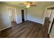 Bedroom with modern ceiling fan, laminate flooring, and closet doors at 7507 Sandstone Dr, Orlando, FL 32836