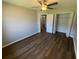 Bright bedroom with modern ceiling fan, laminate flooring, and closet at 7507 Sandstone Dr, Orlando, FL 32836