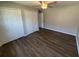 Bedroom with modern ceiling fan, laminate flooring, and closet doors at 7507 Sandstone Dr, Orlando, FL 32836