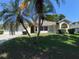 Well-maintained single-Gathering home with lush landscaping, a two-car garage and a welcoming arched entry at 7507 Sandstone Dr, Orlando, FL 32836