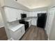 Efficient kitchen features white cabinets, updated appliances, and modern flooring for a sleek design at 7507 Sandstone Dr, Orlando, FL 32836