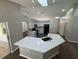 Bright kitchen featuring white cabinetry, quartz countertops, and stainless steel appliances at 7507 Sandstone Dr, Orlando, FL 32836