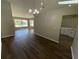 Inviting living space with modern flooring, chandelier lighting and open layout great for entertaining at 7507 Sandstone Dr, Orlando, FL 32836